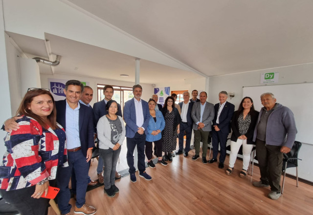 A group of people standing in a room

Description automatically generated
