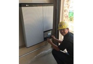 Sullivan Solar Power's superintendent Peter Chiang installing the LG Chem battery
