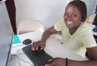 A young African girl learning computer skills on Cudoo.com