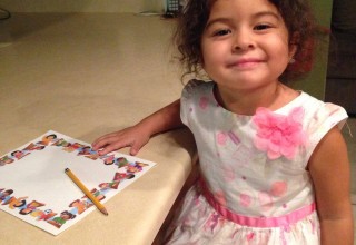 Three-year-old Alexa Martinez as her prepares to write her letter to Santa.