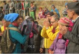 Volunteer Ministers (in yellow) present winter clothing and warm blankets to villagers in Aaru Pokhari, where nearly every one of the 240 households and the village schools suffered severe earthquake damage in the April 2015 earthquake.