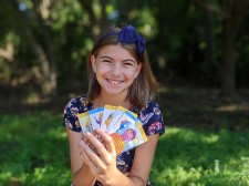 Eva holding her SUNCards that help kids through stressful situations