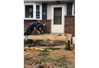 Union Carpenters Hard at Work Building a Wheelchair Ramp