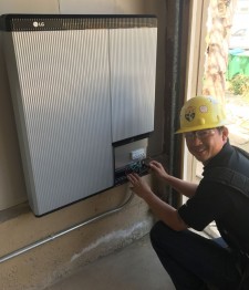 Sullivan Solar Power's superintendent Peter Chiang installing the LG Chem battery