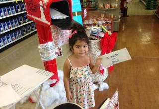 Three-year-old Alexa Martinez sends her letter to Santa at the Crown Ace location in Huntington Beach, Calif.