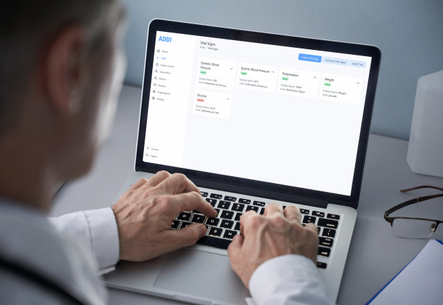 Physician reviewing vitals on the ADDI platform on a computer