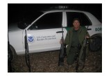 Officer Borkovich with some of the guns used by illegal immigrants 