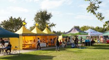 Volunteer Ministers bright yellow tent at National Night Out Against Crime