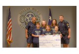 Handing off $11,000 to the Dallas Police