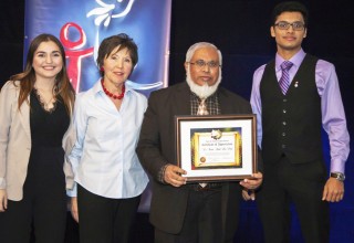 Nicole Crellin and Youth for Human Rights volunteers present an award to Imam Dr. Abdul Hai Patel for his contributions to human rights education