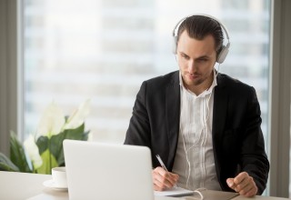 CEO of Small Business Taking Notes from Computer