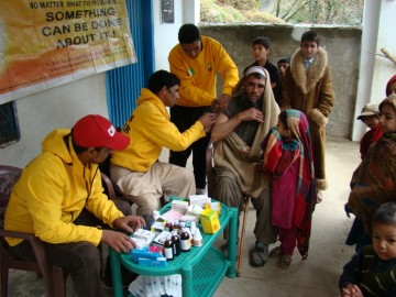 Pakistan Volunteer Assist Team providing medical care in remote village, stranded by the earthquake.