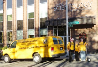 Scientology Volunteer Ministers load up their van with donated goods for those in need. 