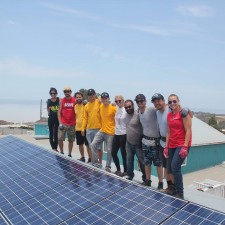 The Sol Collective's volunteers and first donated system 