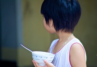 Vietnamese girl waiting for her rice 