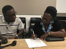 Robinah Lubwama is signing agreement with DTML.org