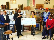 Freedom Ties presents check to Black World Books