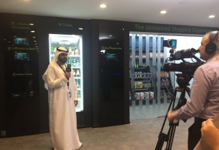 A reporter from the official media outlet of etisalat is doing a report on the AI cooler