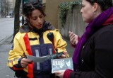 Volunteer hands out copies of The Truth About Drugs as part of a drug prevention workshop.