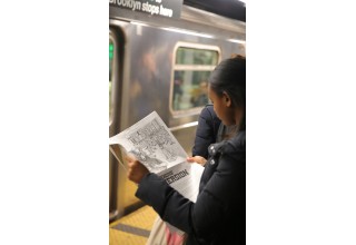 Article being read on NYC subway platform