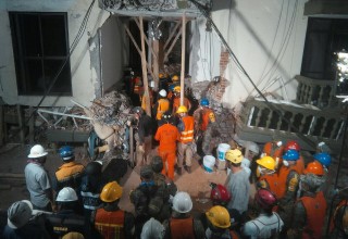 Rescue workers stand by to help at Enrique Rebsamen School, waiting for word about Paulina Gomez, one of the children trapped under the rubble.