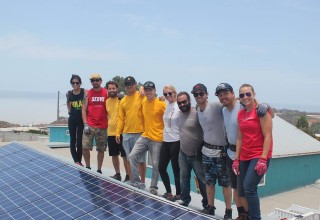 The Sol Collective's volunteers and first donated system 