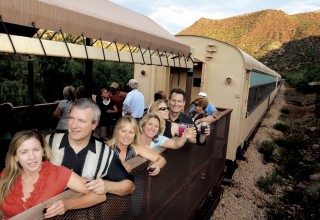 Passengers savoring the cooling evening air aboard Verde Canyon Railroad's Summer Starlight ride