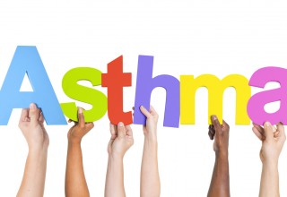 Hands holding letters spelling asthma