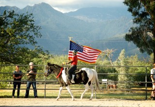 Veteran rider carrying the flag