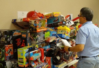 Dr. Norman Quintero goes over list of toys donated