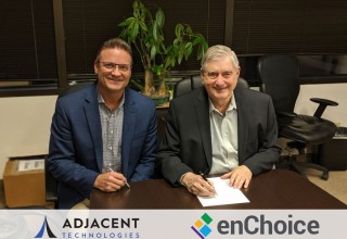 Dave Parks, CEO of Adjacent Technologies, and Tony White, CEO of enChoice, sign the merger agreement.