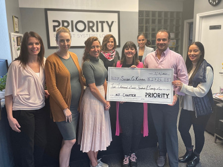 President Angelo Mendola presents check to Susan G. Komen.