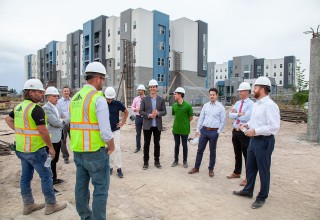 Small group walking tour of The Hub Apartments site