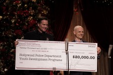 LAPD Hollywood Division Area Commander Captain Cory Palka stepped accepts a $20,000 check from Celebrity Centre Vice President Greg LaClaire—funds raised by the 24th annual Christmas Stories to support Hollywood Police Department programs for at-risk youth.