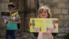 Refugee girl receives a book from Bookwitty