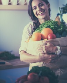 Woman Holding Grocery Bag Filled with Produce