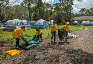 A team of Volunteer Ministers cleans up the grounds at Pinellas County Hope shelter.