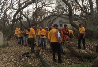 Clearing fallen trees and debris from homes after Hurricane Harvey