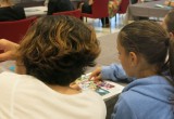 Youth attending the drug prevention open house at the Church of Scientology Milan discuss The Truth About Drugs materials