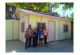 The Real Family standing in front of their new home in Tijuana.
