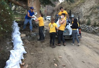 Still early in the rainy season, Volunteer Ministers help protect homes with sandbags to protect against further floods and mudslides.