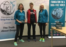 Foundation for a Drug-Free World volunteers (in aqua  shirts and jackets) at a drug education program presented  to students at Resurrection Catholic Secondary School in  Waterloo, Ontario.