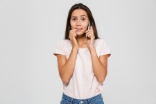 Woman Looking Worried While on the Phone