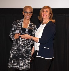Dr. Bello gives Diana Rowan Rockefeller the Woman of the Year Award January 2019