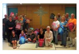 Volunteers from Interfaith Ministries of Greater Queen Anne at a luncheon at the Church of Scientology Seattle, where they prepared backpacks and school supplies for local underserved children in the new school year.