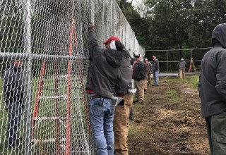 100 Percent of RGF Employees Working Together on 10-foot-high Fence Installation