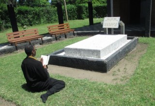 Anthony "Amp" Elmore does Buddhist Prayers at the grave of Kenya Hero Tom Mboya. Elmore wants the world to learn about Tom Mboya.