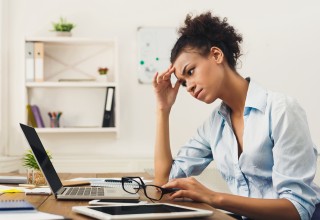 Stressed Woman on Computer at Home