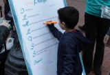 Youngster signs the Foundation for a Drug- Free World's drug-free pledge.
