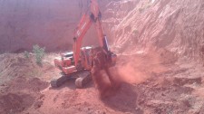 Excavator inside new mining pit